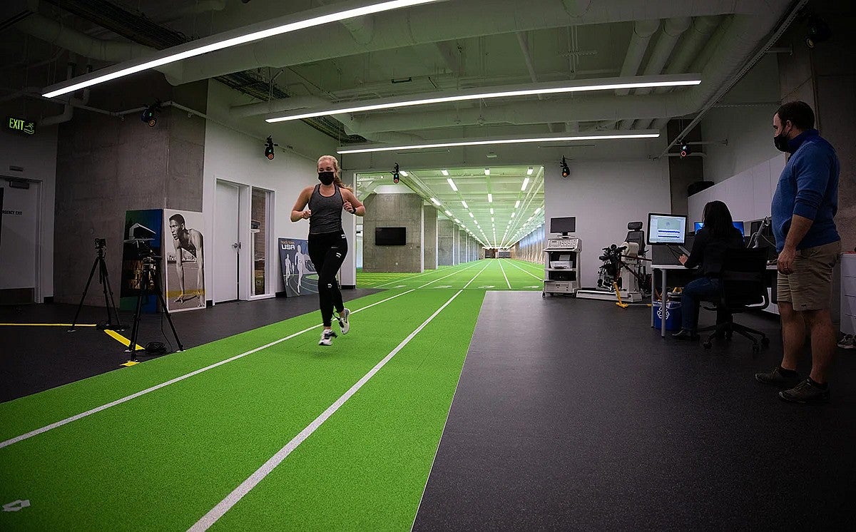 Woman running on an indoor track in a research facility