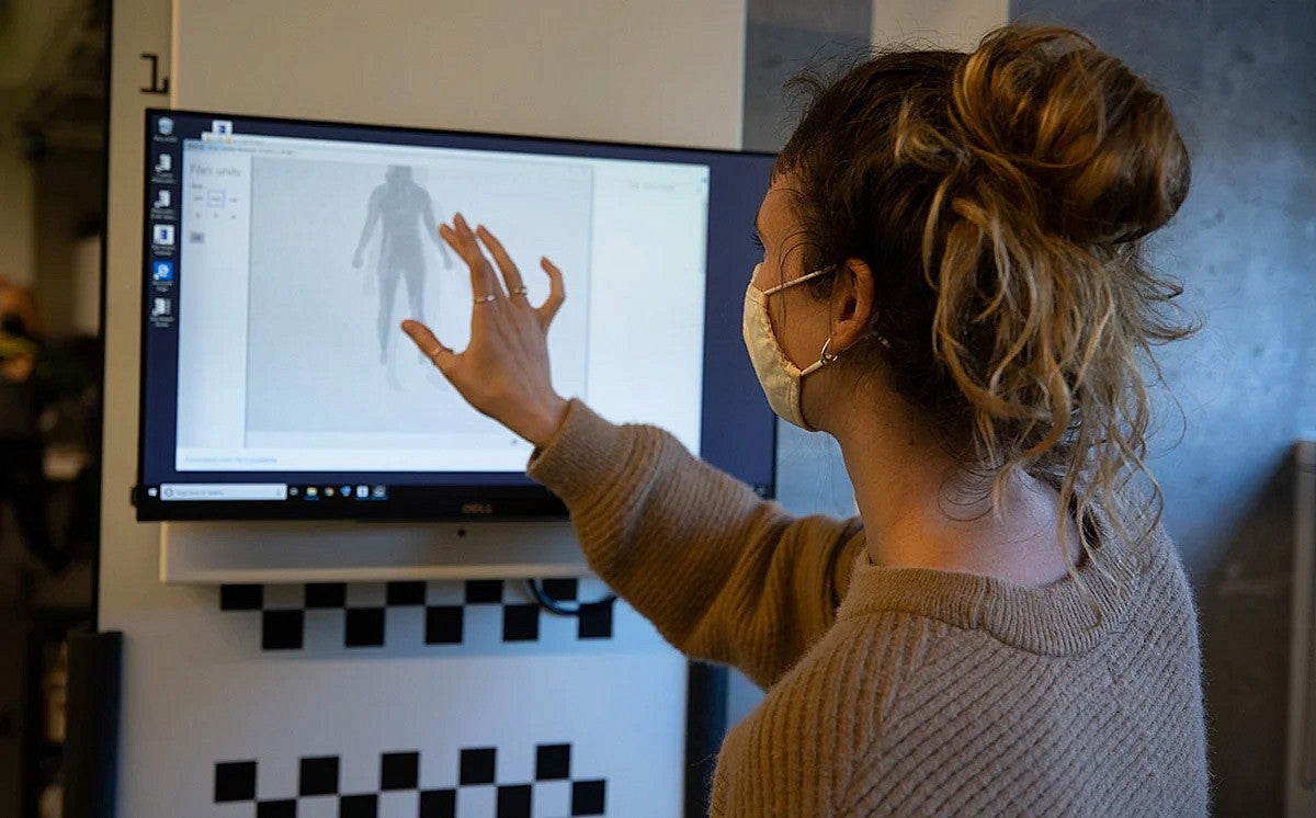 Woman standing in front of a monitor in a lab