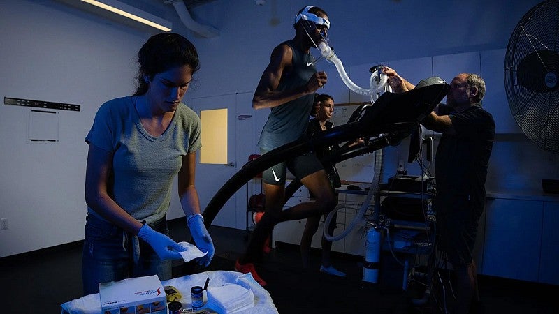 a person on a treadmill with researchers working around them