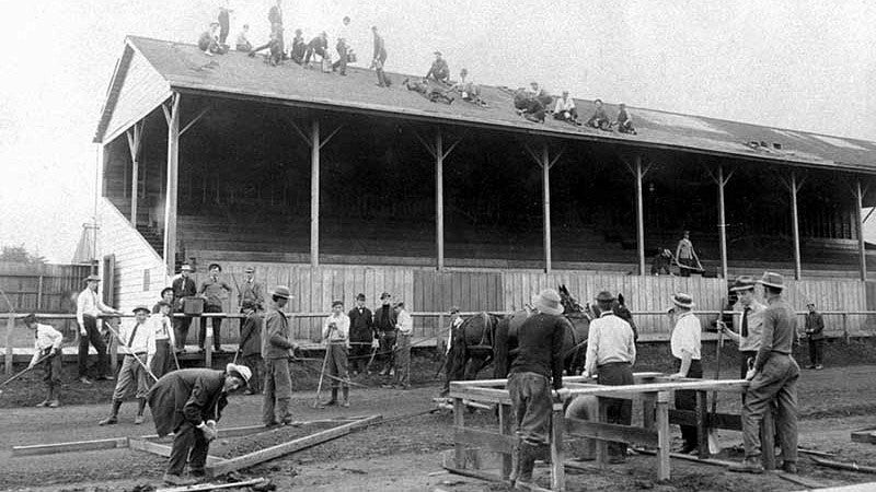 Men working at Hayward to install the new cinder track