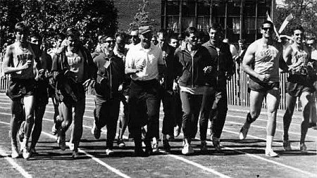 Members of the University of Oregon‘s 1964 national champion men‘s tck and field team, led by coach Bill Bowerman (near middle wearing hat), as they take a victory lap at Hayward Field Members of the University of Oregon‘s 1964 national champion men‘s tck and field team, led by coach Bill Bowerman (near middle wearing hat), as they take a victory lap at Hayward Field