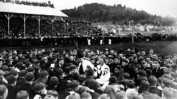 Two UO yell kings in the middle of a throng of students at Hayward Field on November 15, 1919, prior a football game against Oregon Agricultural College.